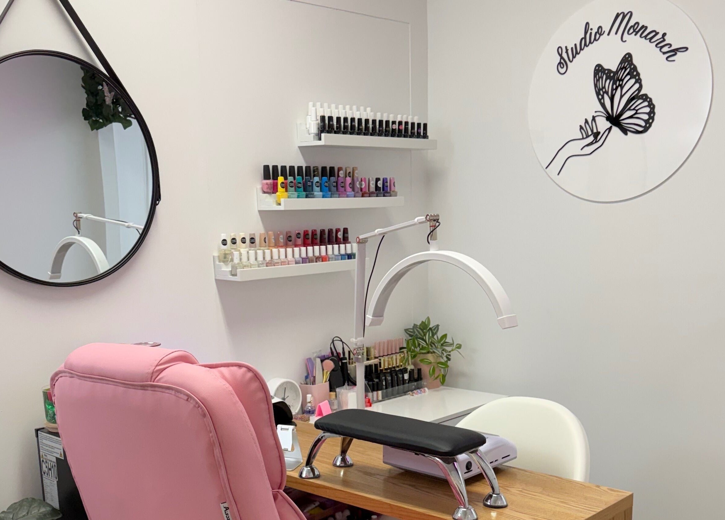 Chic nail station at Studio Monarch by Leia Ebert, Bundall, Queensland, AU, featuring colorful nail polishes.