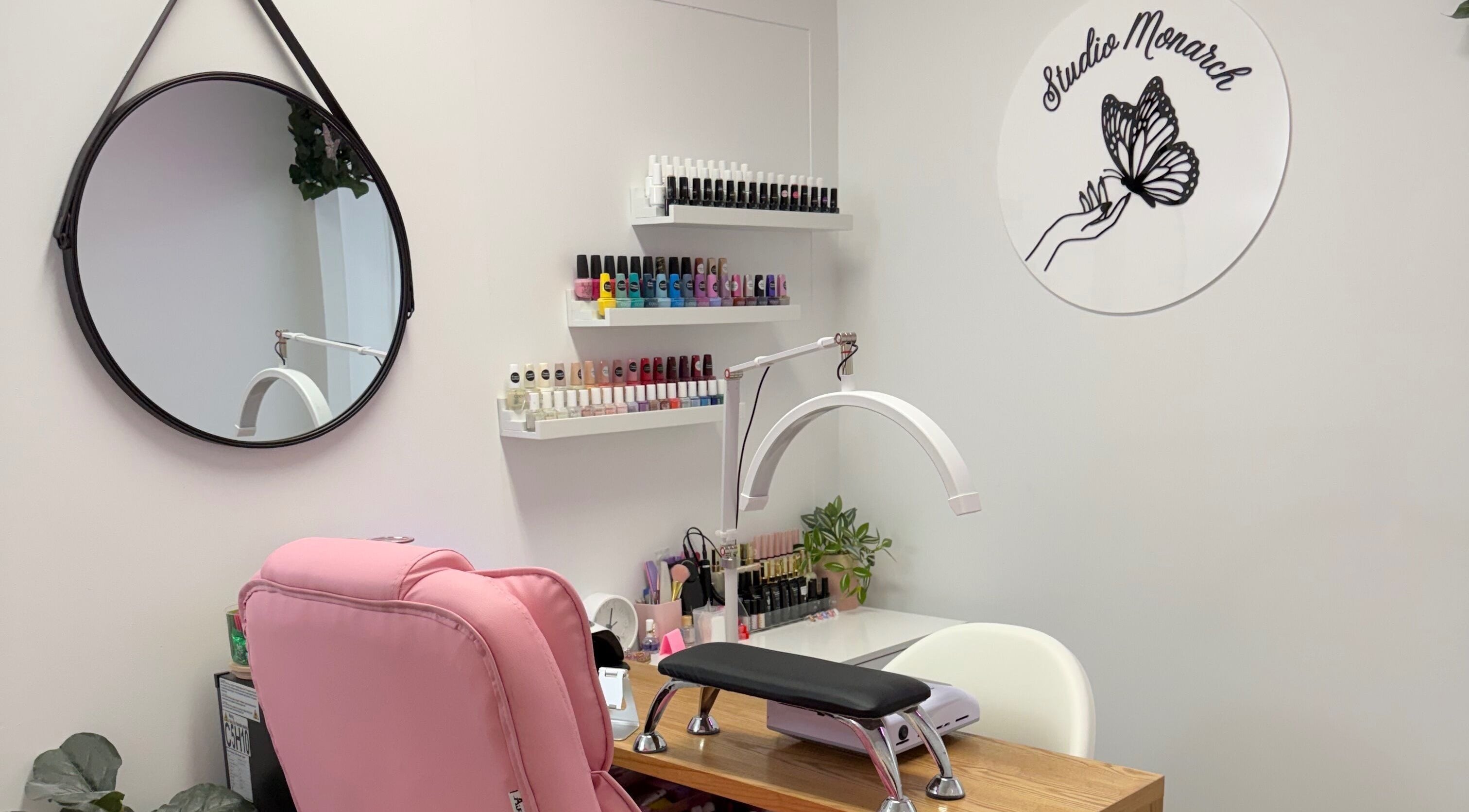 Chic nail station at Studio Monarch by Leia Ebert, Bundall, Queensland, AU, featuring colorful nail polishes.