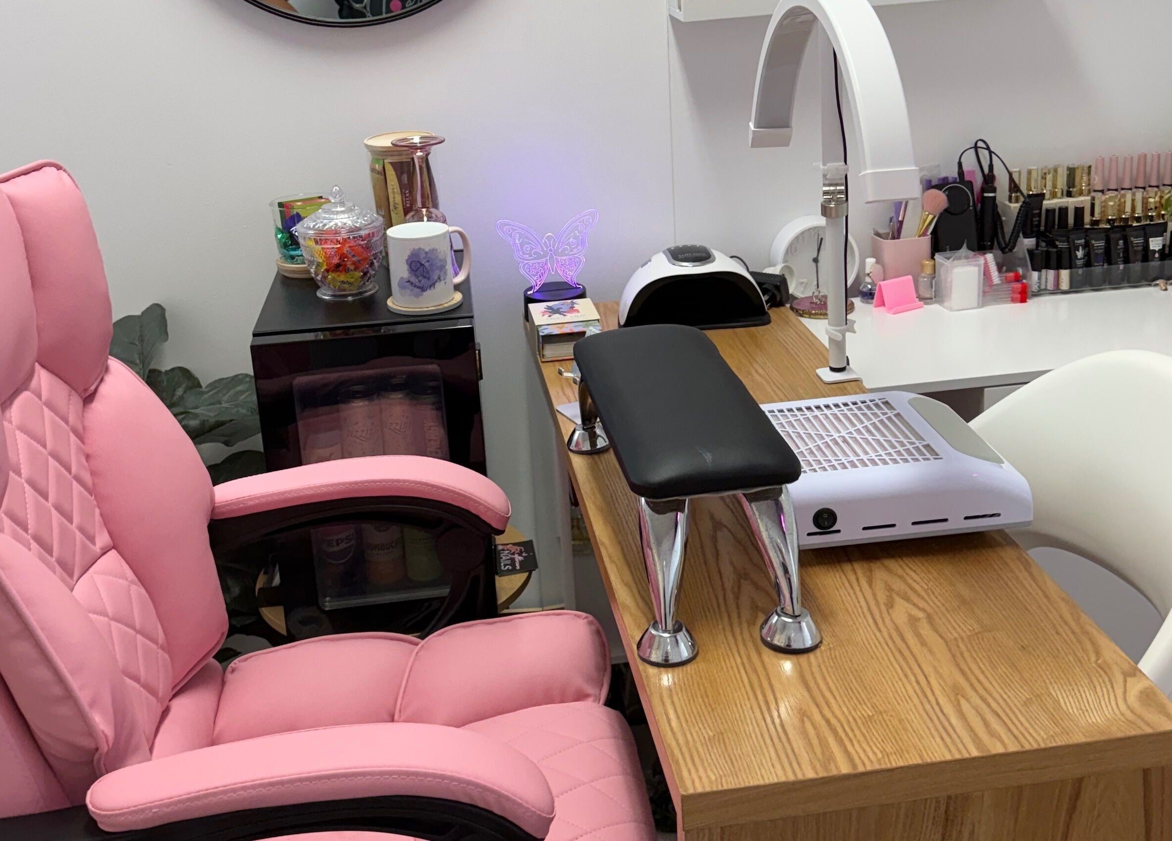 Comfortable nail station at Studio Monarch by Leia Ebert, Bundall, Queensland, AU, featuring pink chair and supplies.