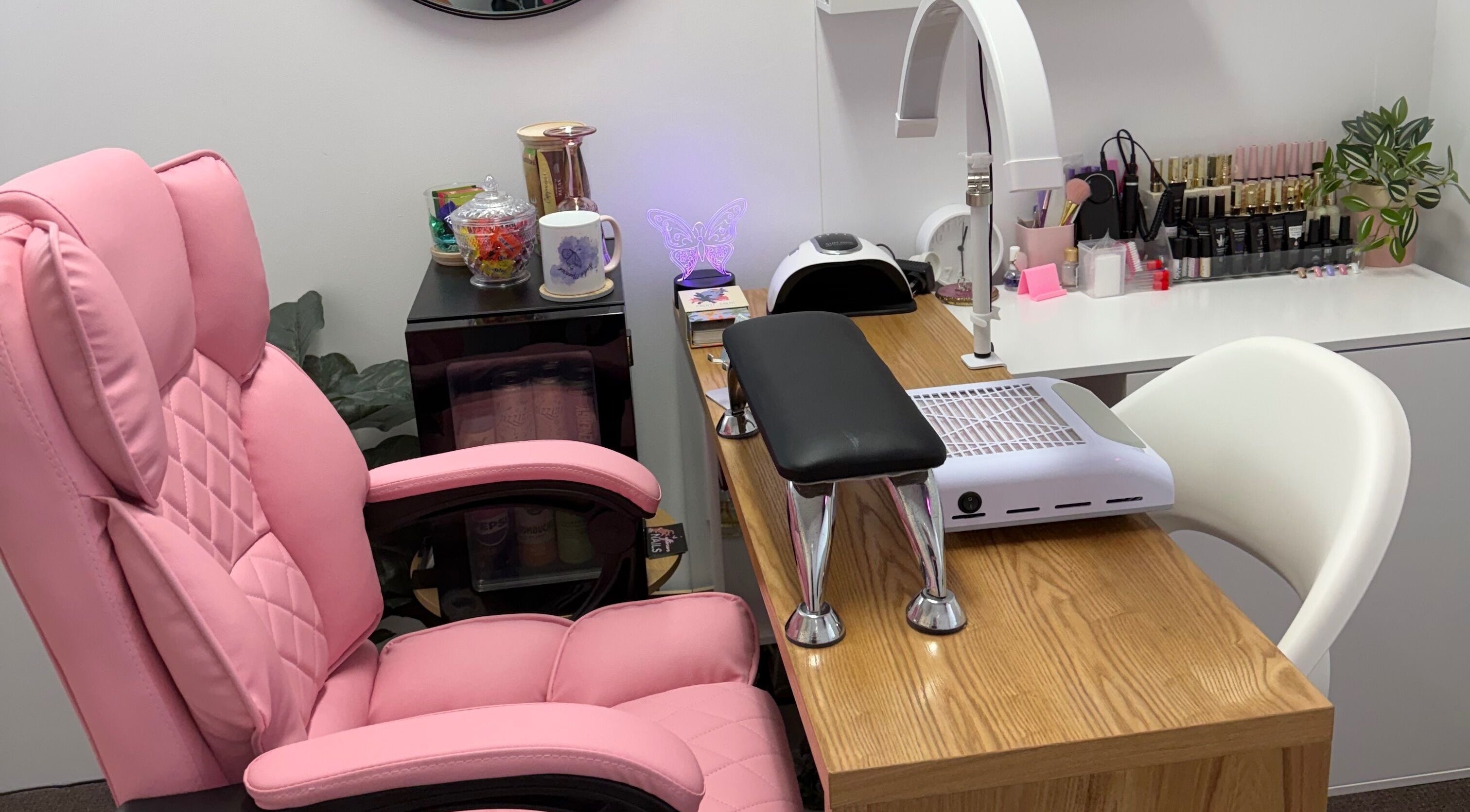 Comfortable nail station at Studio Monarch by Leia Ebert, Bundall, Queensland, AU, featuring pink chair and supplies.