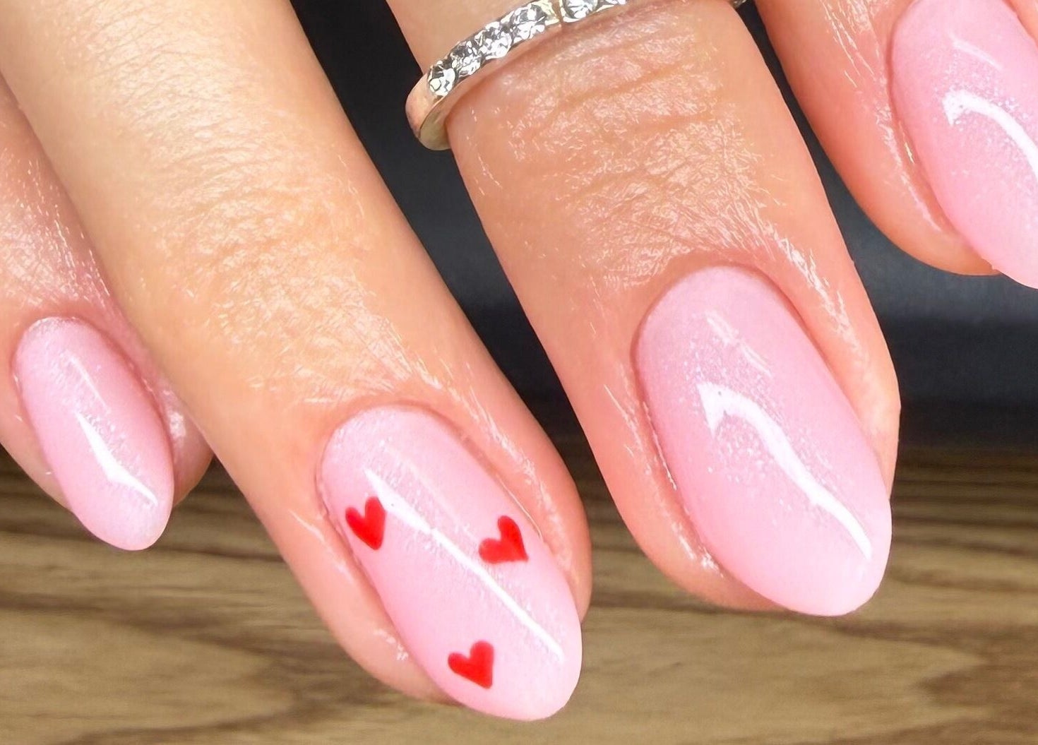 Pink manicured nails with red hearts at Studio Monarch by Leia Ebert, Bundall, Queensland, AU.