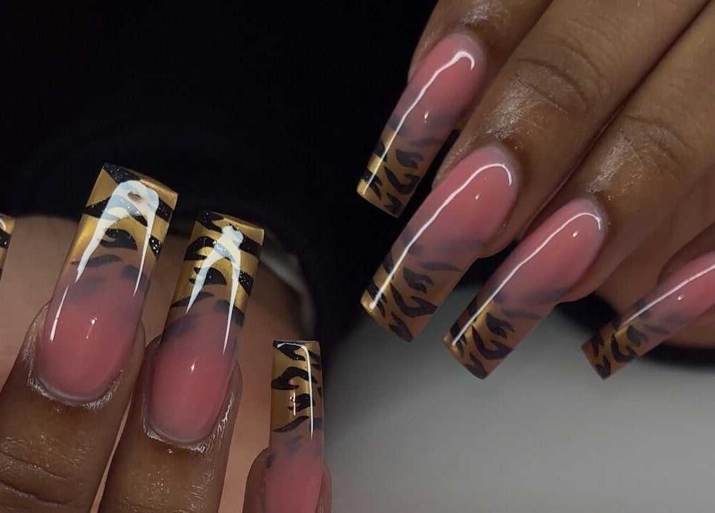 Stylish nail art featuring bold tiger stripe tips at Brushed by Jay D, Tallahassee, Florida, US.