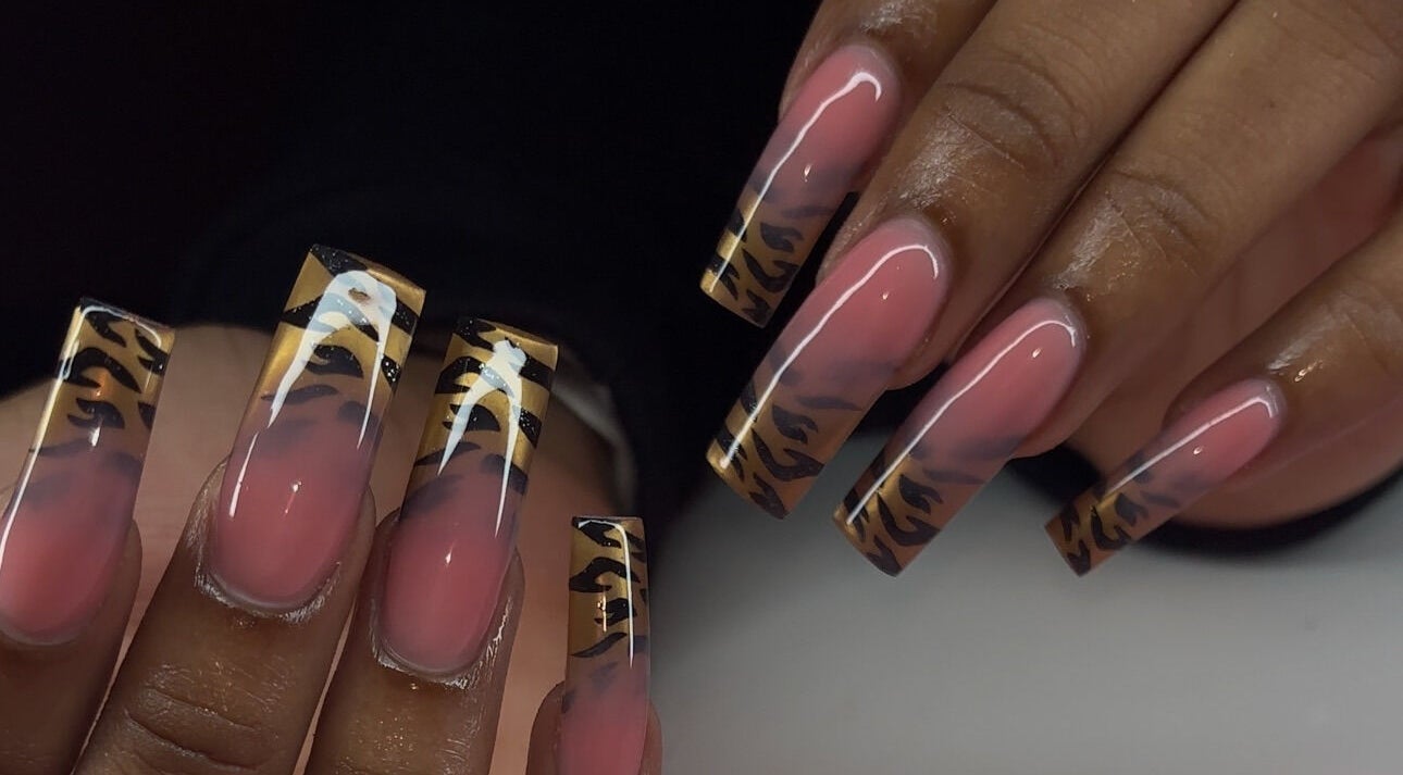 Stylish nail art featuring bold tiger stripe tips at Brushed by Jay D, Tallahassee, Florida, US.