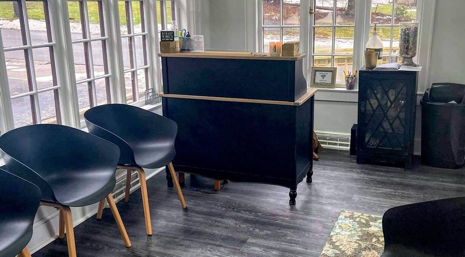 Elegant reception area at Mirage Salon, Jamestown, New York, US with modern seating and large windows.