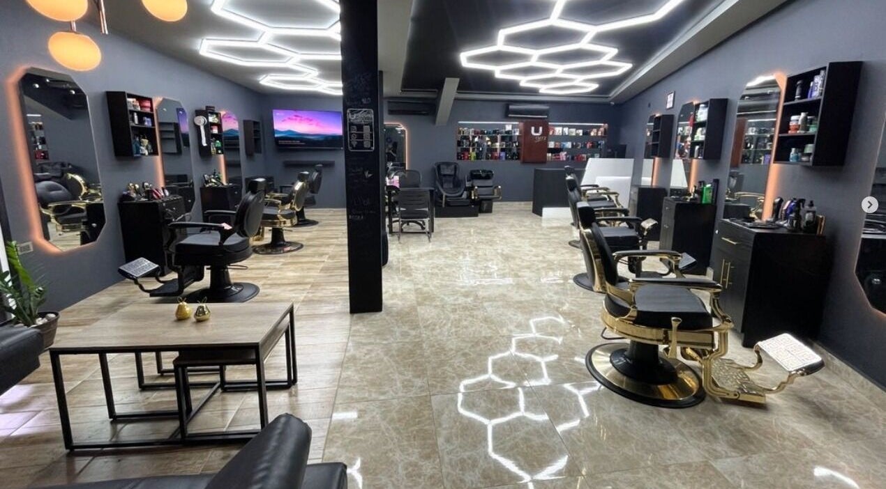 Modern interior of Unique Cutz Barbershop in Santiago De Los Caballeros, Santiago, DO with sleek decor.