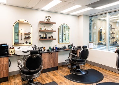 Chic interior of True Cut Barber Studio, Sydney, New South Wales, AU, featuring stylish chairs and decor.