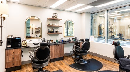 Chic interior of True Cut Barber Studio, Sydney, New South Wales, AU, featuring stylish chairs and decor.