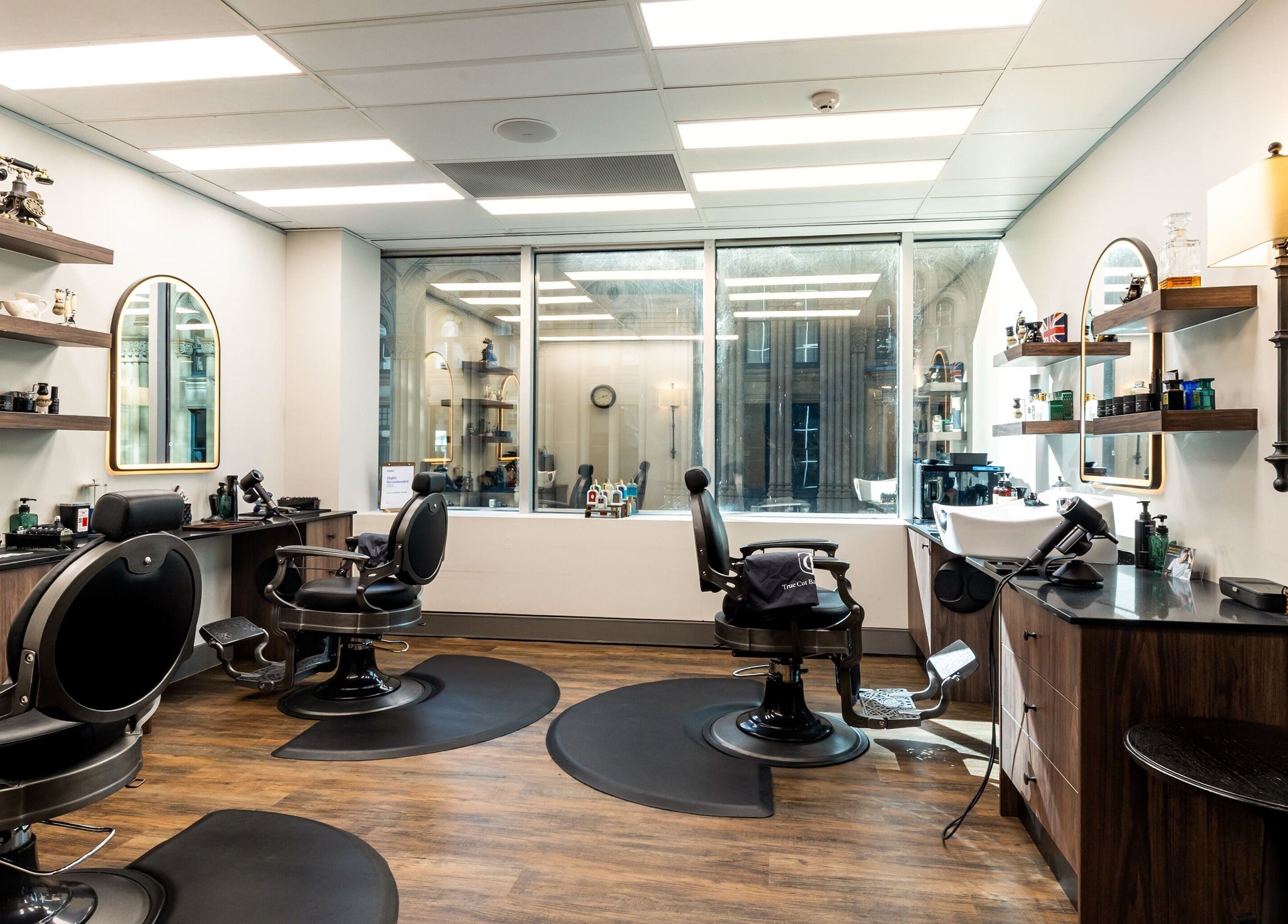 Elegant interior of True Cut Barber Studio in Sydney, NSW, AU, featuring modern barber chairs and stylish decor.