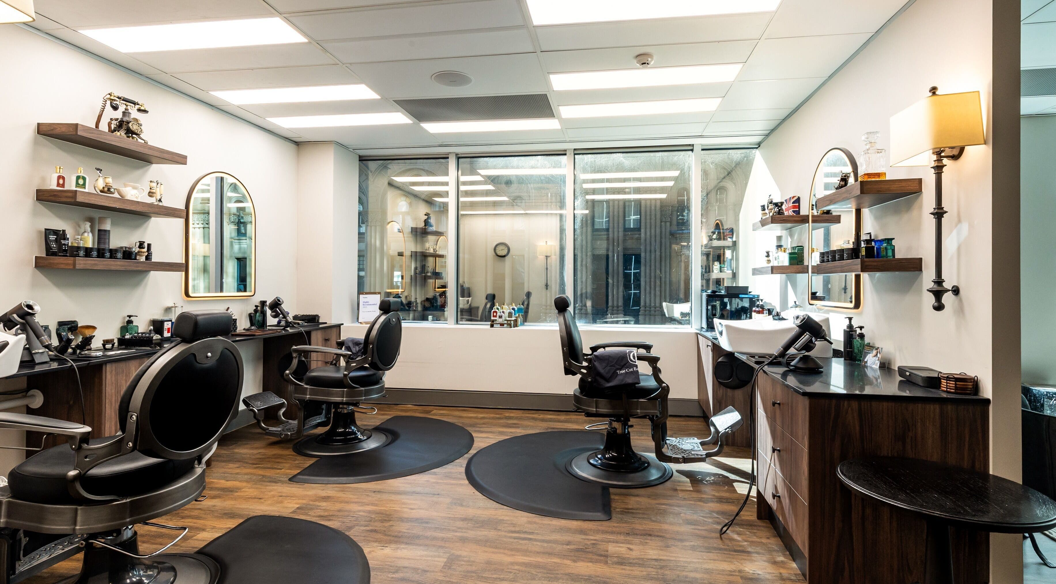 Elegant interior of True Cut Barber Studio in Sydney, NSW, AU, featuring modern barber chairs and stylish decor.