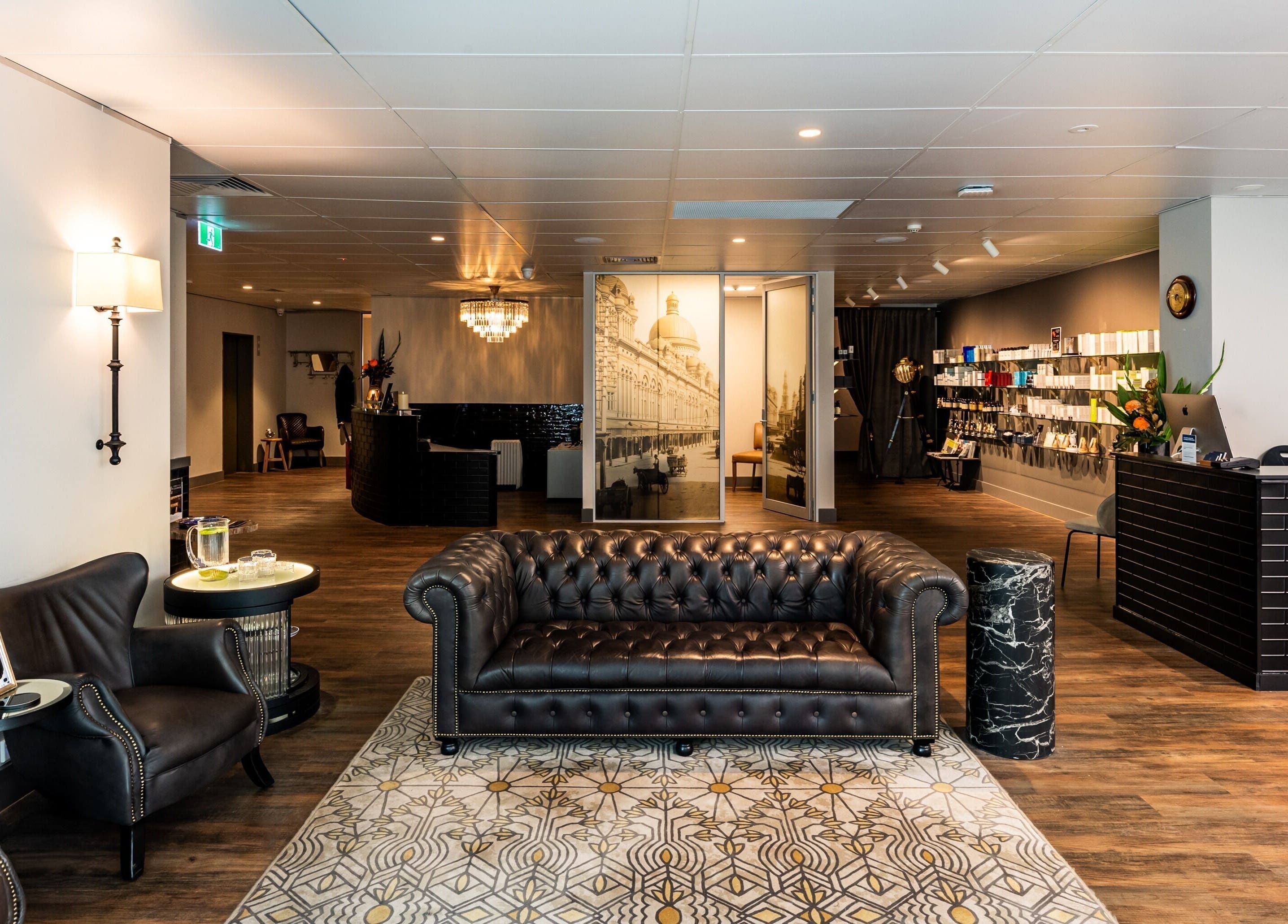 Elegant lounge area at True Cut Barber Studio, Sydney, New South Wales, AU showcasing leather seating and modern decor.