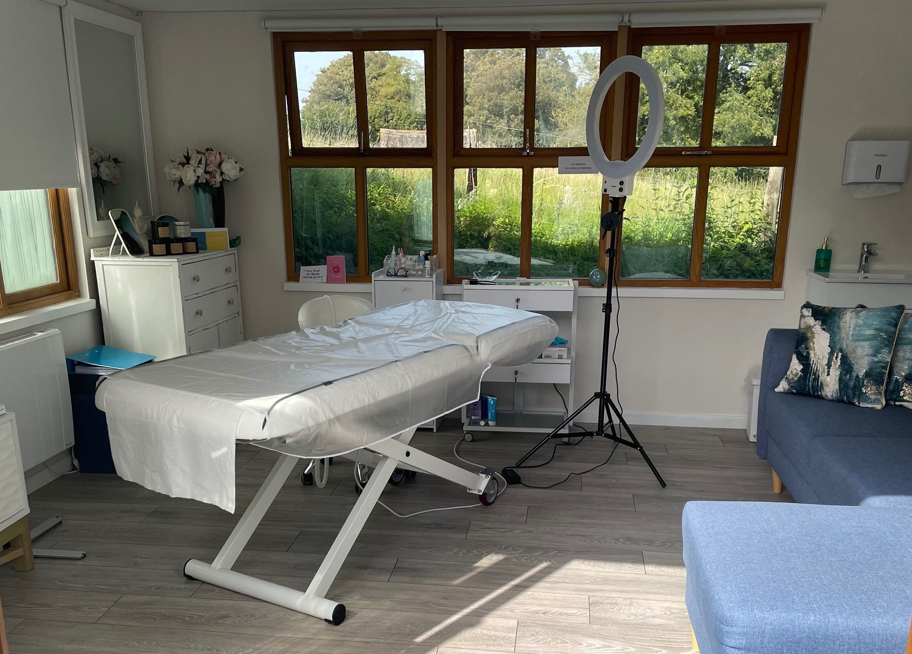 Calm treatment room at Rachael Loco Permanent Makeup in Dorchester, England, GB, with a comfortable bed.