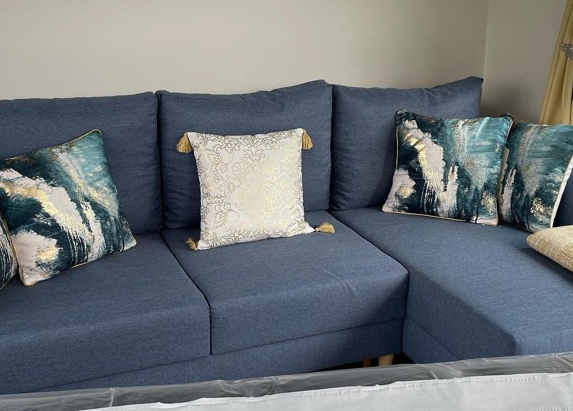 Elegant blue sofa with artistic pillows at Rachael Loco Permanent Makeup, Dorchester, England, GB.