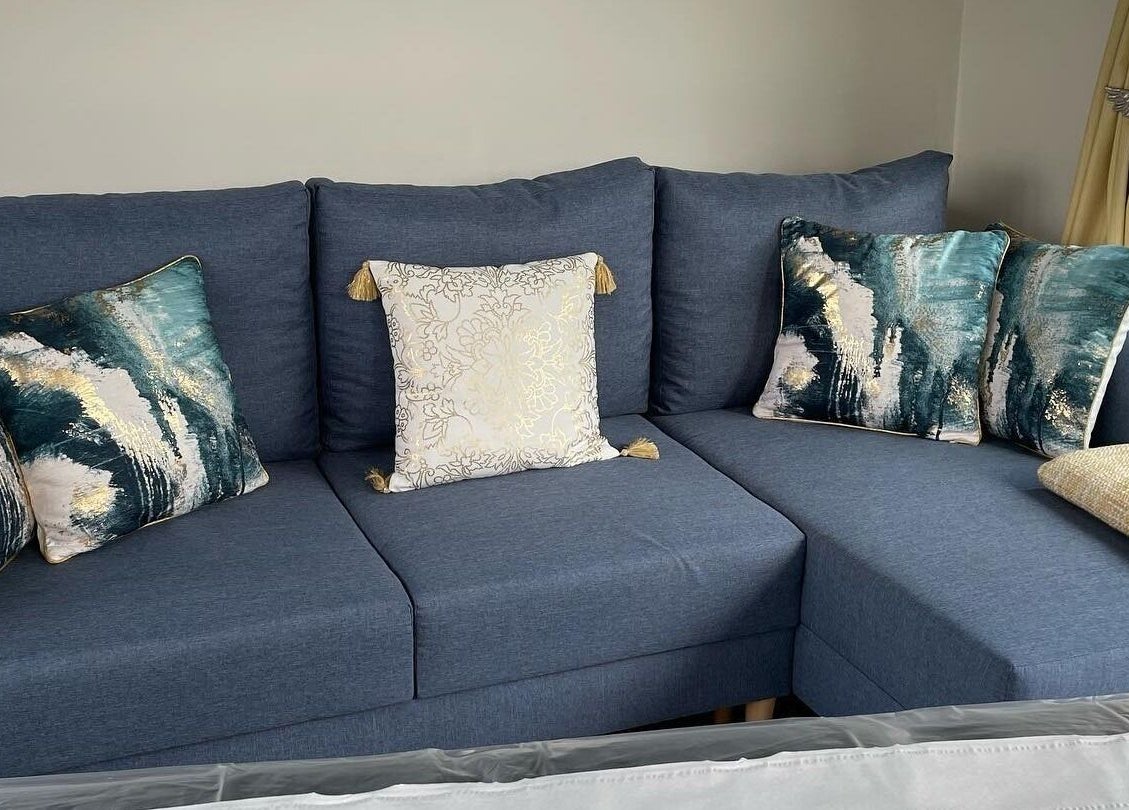 Elegant blue sofa with artistic pillows at Rachael Loco Permanent Makeup, Dorchester, England, GB.