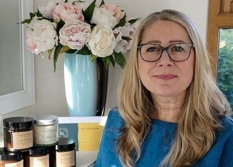 Cozy corner at Rachael Loco Permanent Makeup, Dorchester, England, with flower vase and beauty products.