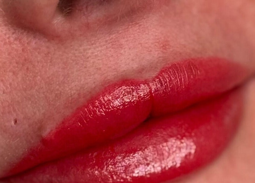 Close-up of vibrant red lips at Rachael Loco Permanent Makeup in Dorchester, England, GB.