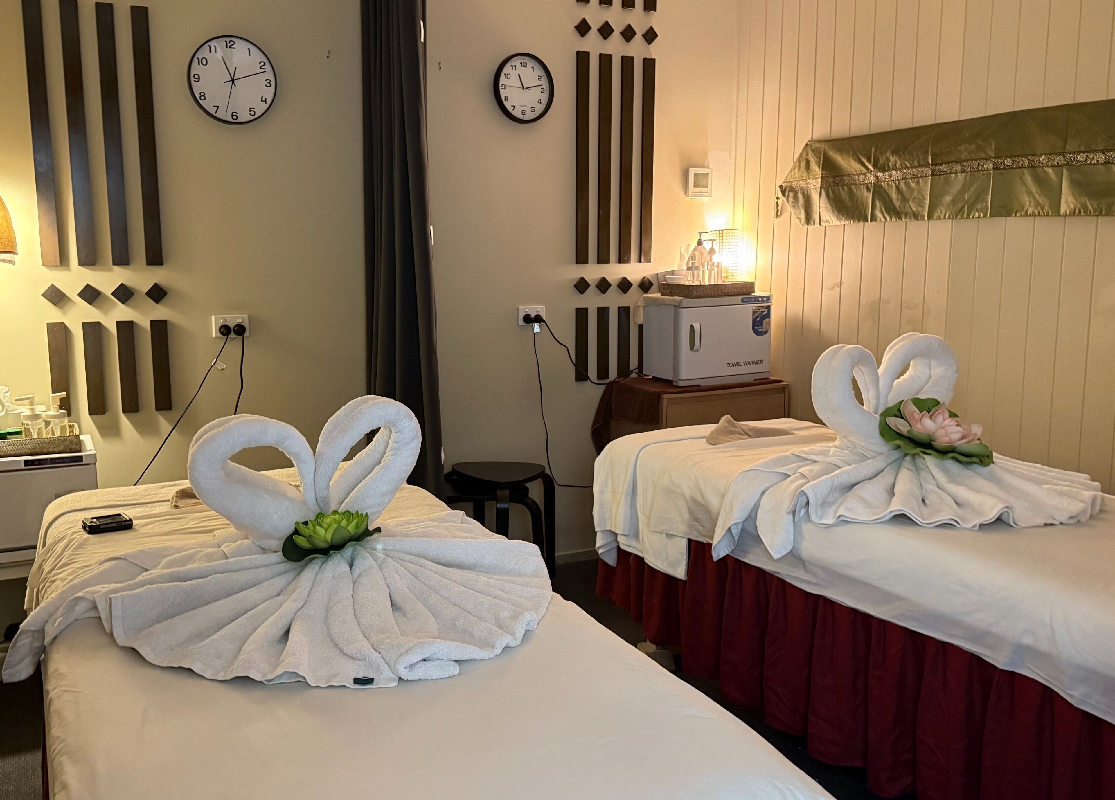 Calming twin massage beds at Ploythai Massage and Spa, Wynnum, Queensland, AU with elegant towel swans.