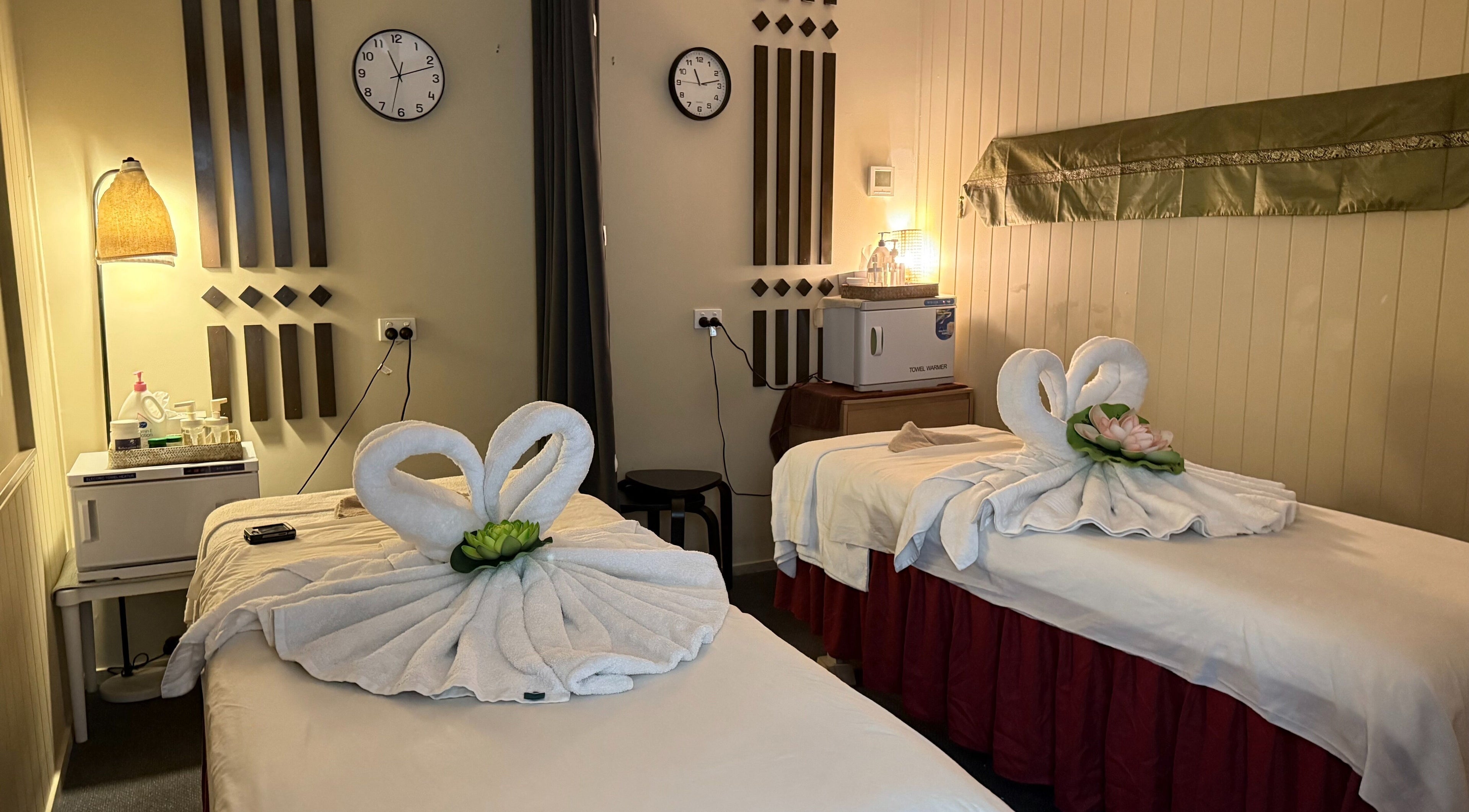 Calming twin massage beds at Ploythai Massage and Spa, Wynnum, Queensland, AU with elegant towel swans.