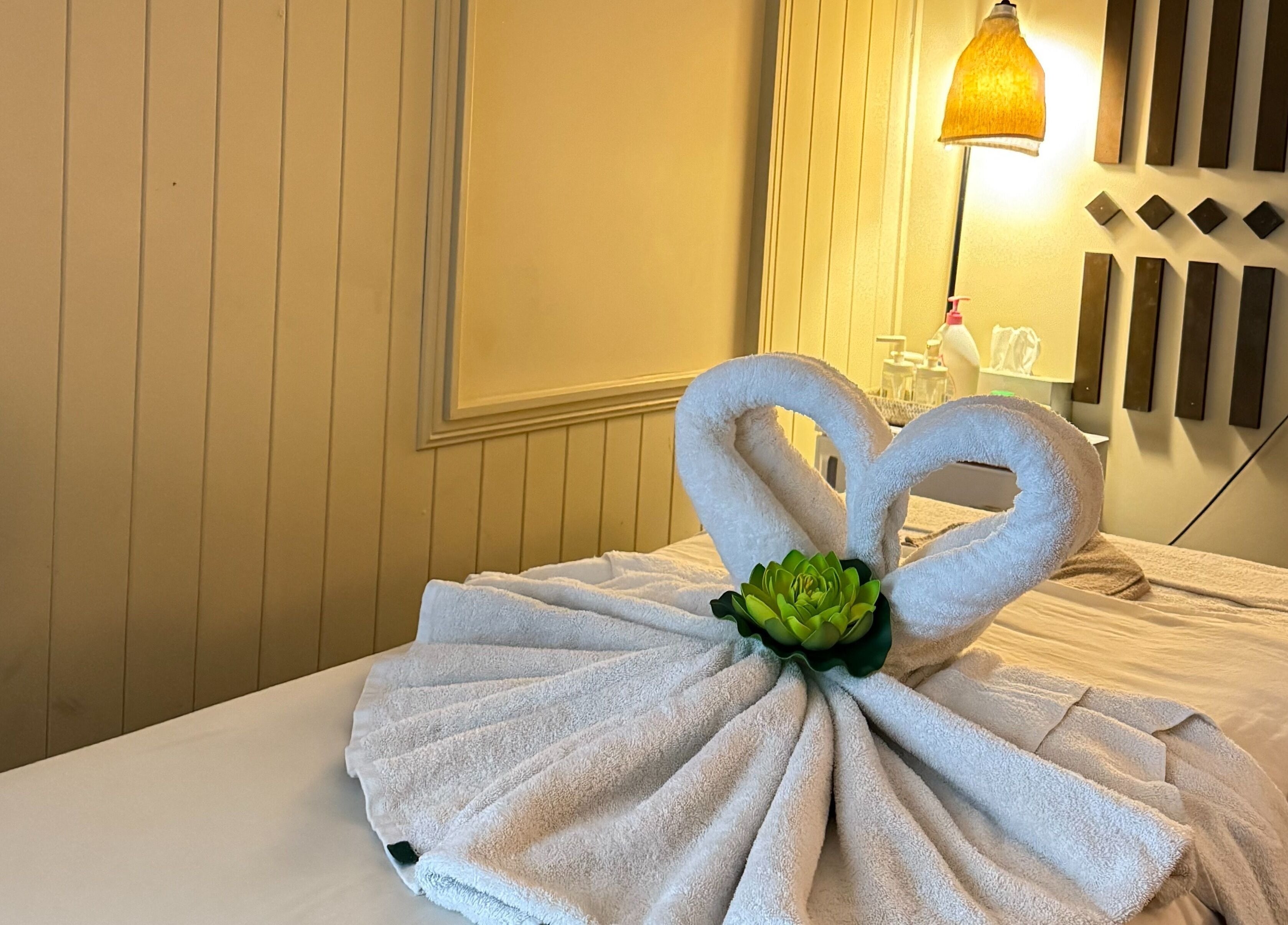 Elegant towel swans on a massage table at Ploythai Massage and Spa, Wynnum, Queensland, AU.
