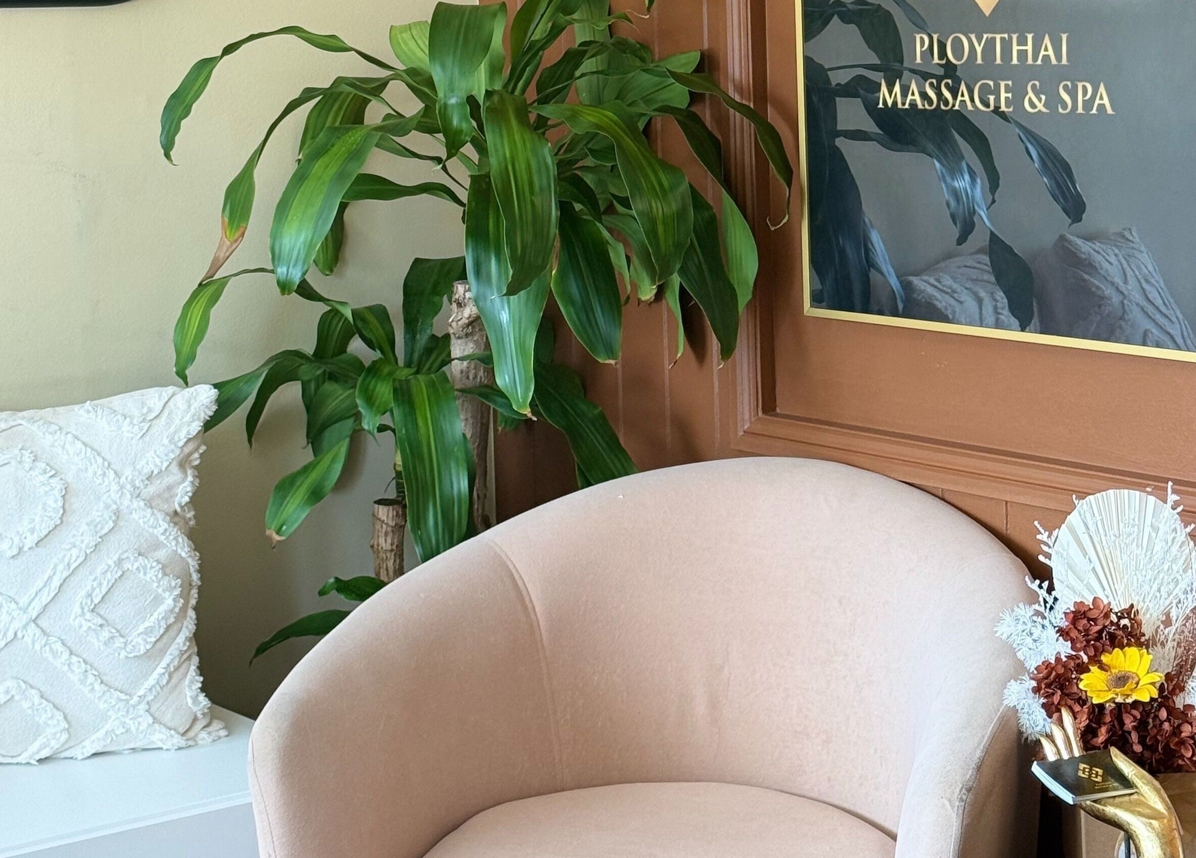 Welcoming seating area at Ploythai Massage and Spa, Wynnum, Queensland, AU with lush plants and stylish decor.