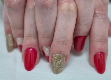 Elegant red and gold glitter nails at Ju'sbeauty, Newcastle upon Tyne, England, GB.
