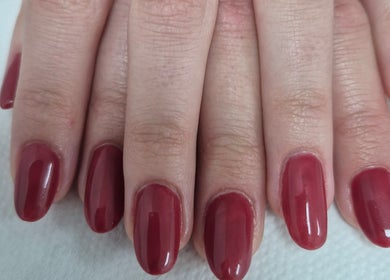 Elegant red manicure at Ju'sbeauty, Newcastle upon Tyne, England, GB. Perfectly shaped and polished nails.