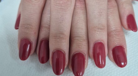 Elegant red manicure at Ju'sbeauty, Newcastle upon Tyne, England, GB. Perfectly shaped and polished nails.