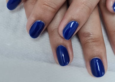 Close-up of navy blue polished nails at Ju'sbeauty, Newcastle upon Tyne, England, GB.