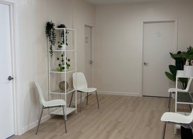 Calm waiting area at BlushTan Worcester with sleek chairs and greenery, Worcester, Massachusetts, US.