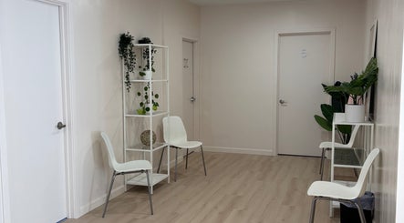 Calm waiting area at BlushTan Worcester with sleek chairs and greenery, Worcester, Massachusetts, US.