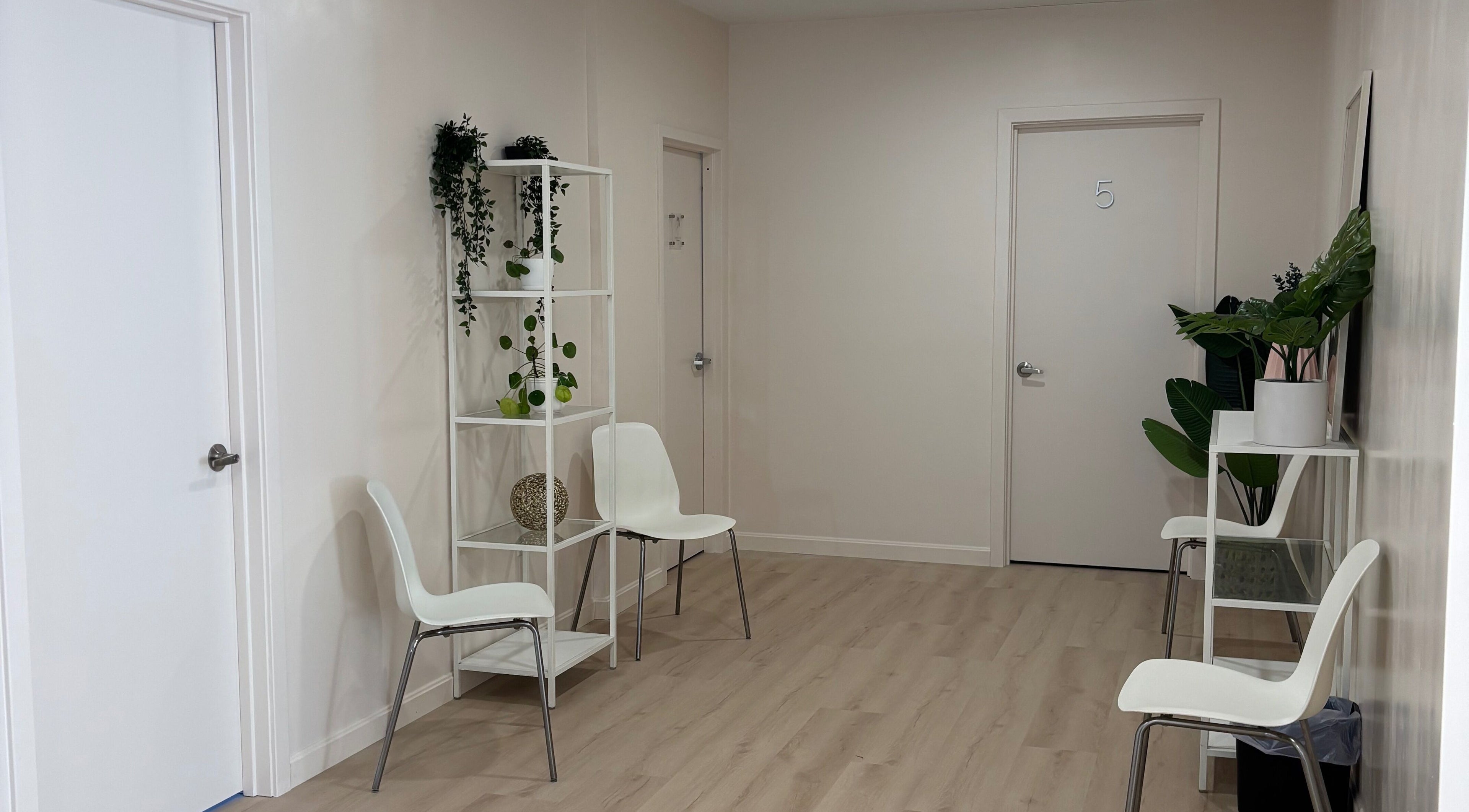 Calm waiting area at BlushTan Worcester with sleek chairs and greenery, Worcester, Massachusetts, US.