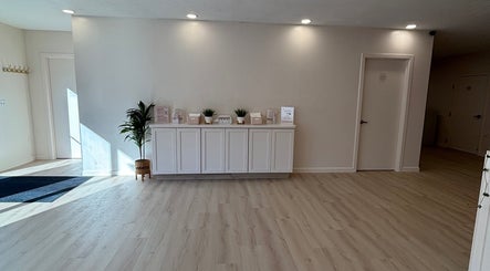 Modern reception area at BlushTan Worcester, Massachusetts, US with light wood floors and elegant decor.