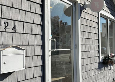 Entrance door to BlushTan Worcester with shingled exterior and address 124 Worcester, Massachusetts, US.