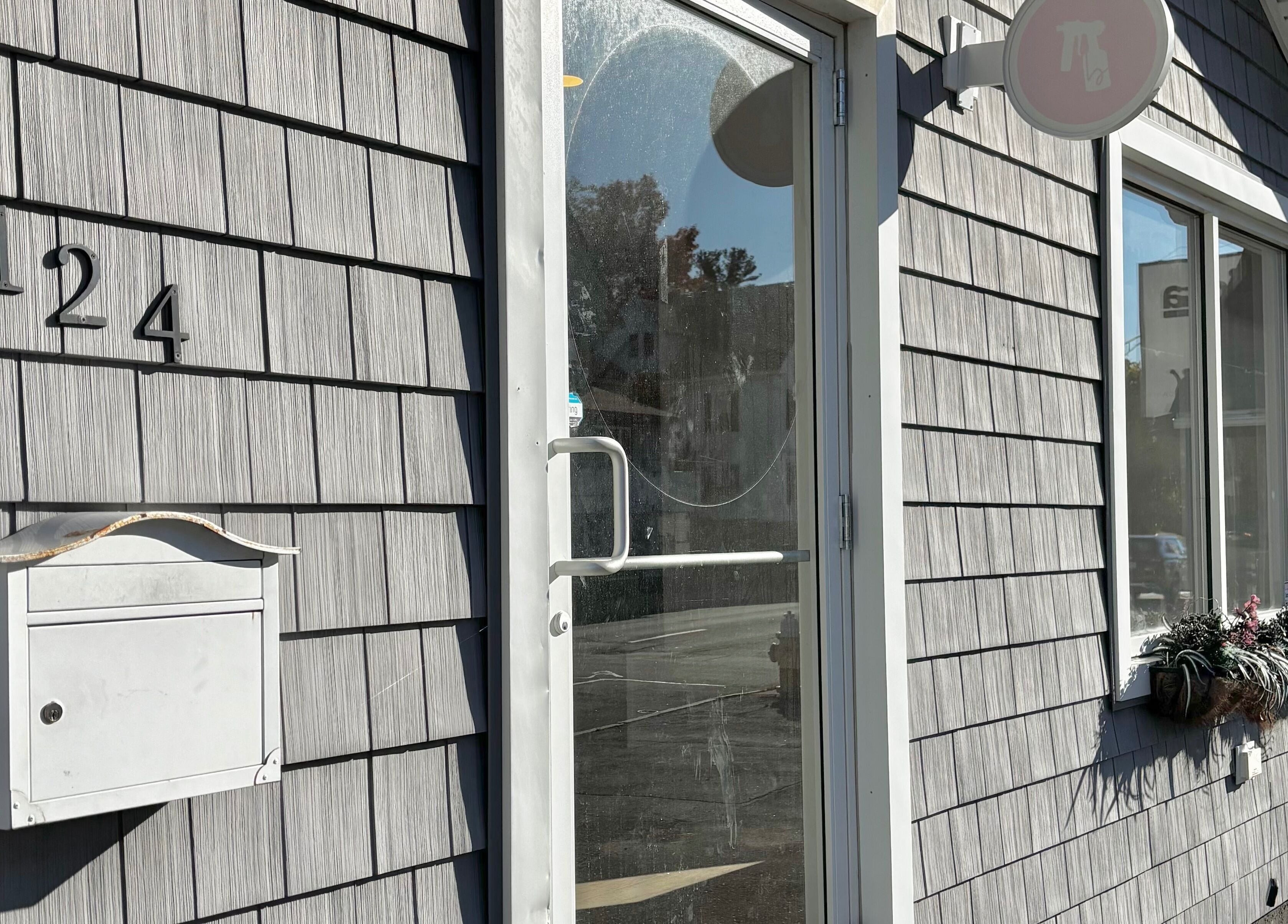 Entrance door to BlushTan Worcester with shingled exterior and address 124 Worcester, Massachusetts, US.