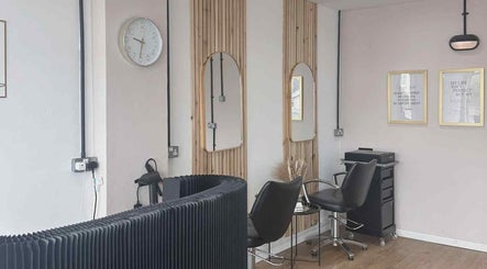 Modern salon interior at The Crop Shop, Saint Athan, Wales, GB, featuring stylish chairs and mirrors.