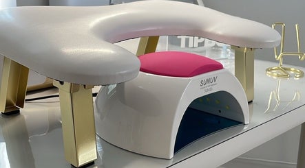 Nail station at BeautyGaze in London, England, GB featuring modern UV lamp and manicure setup.