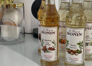 Monin syrups on counter at BeautyGaze, London, England, GB, enhancing the venue's charming ambience.