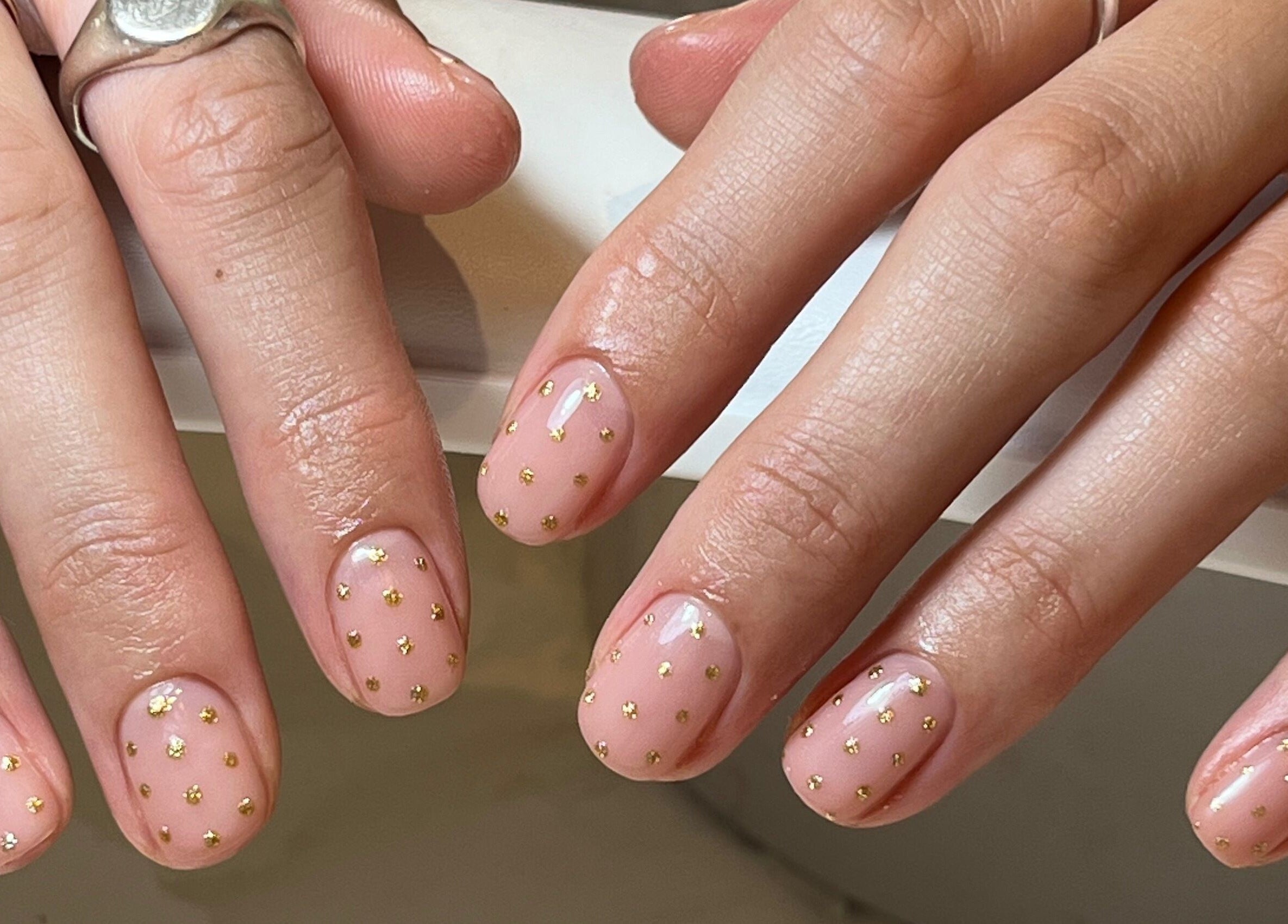Elegant gold-dotted manicure at By Emily Francesca - Langford, Langford, England, GB. Nail art with subtle glam.