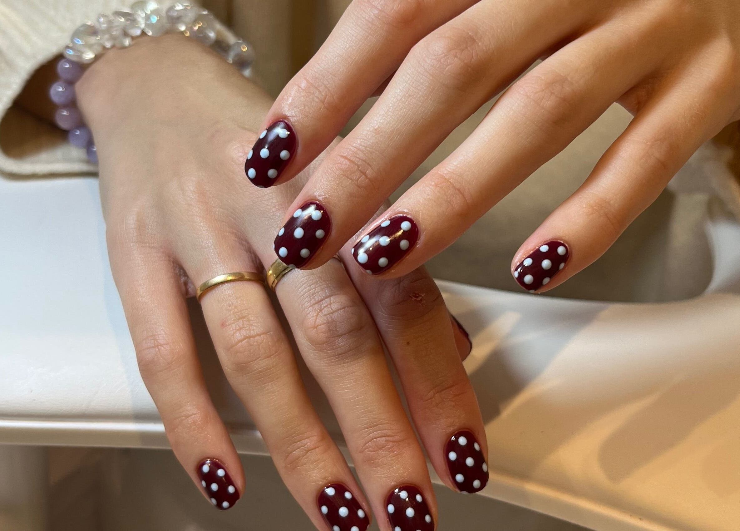 Stylish polka dot nail art by Emily Francesca in Langford, England, GB. Perfect for a chic makeover.