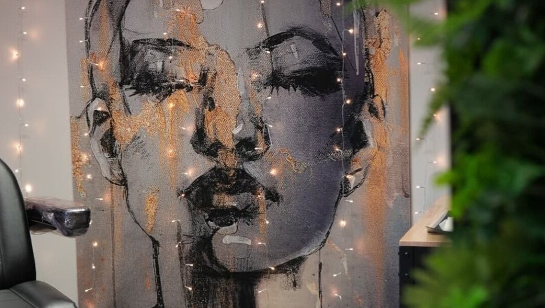 Artistic wall decor at Signature Laser, Kintore, Scotland, GB featuring a portrait with ambient lighting.