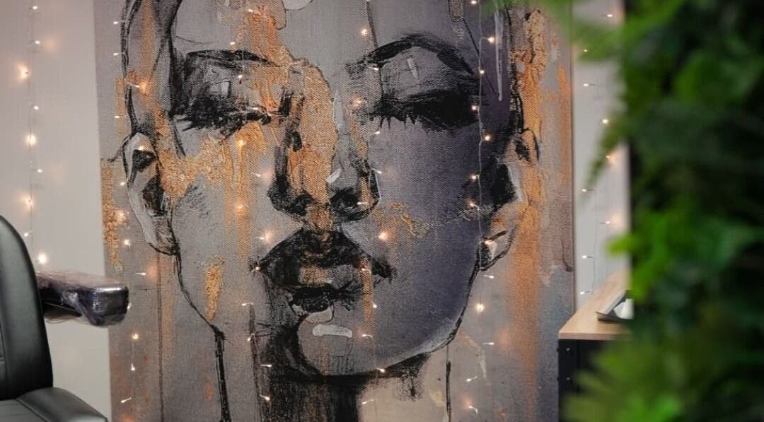 Artistic wall decor at Signature Laser, Kintore, Scotland, GB featuring a portrait with ambient lighting.