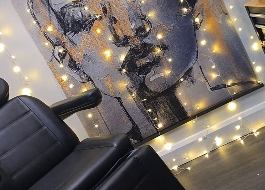 Modern black chair with artistic backdrop and lights at Signature Laser, Kintore, Scotland, GB.