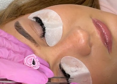 Client receiving eyelash extensions at Pretty by Millie, Bewdley, England, GB. Gentle process with pink gloves.