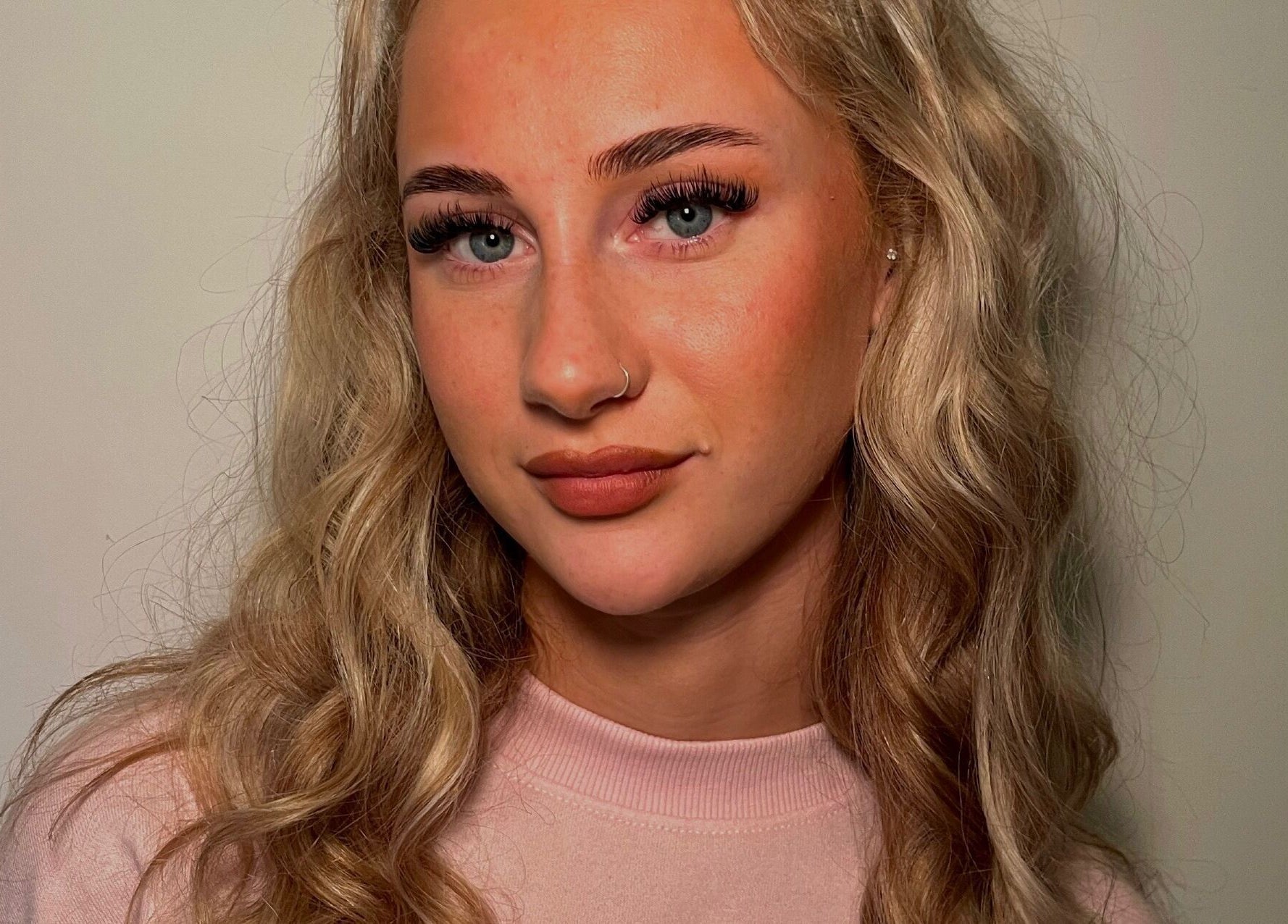 Woman with glowing skin and styled hair at Pretty by Millie, Bewdley, England, GB.