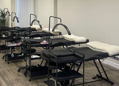 Elegant treatment area at Mnk Beauty, Nottingham, England, GB showcasing comfortable massage tables and modern decor.