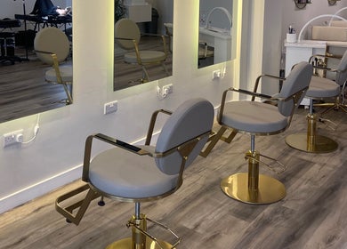 Modern salon chairs at Mnk Beauty, Nottingham, England, GB with luxurious mirrors and sleek design.