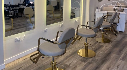 Modern salon chairs at Mnk Beauty, Nottingham, England, GB with luxurious mirrors and sleek design.