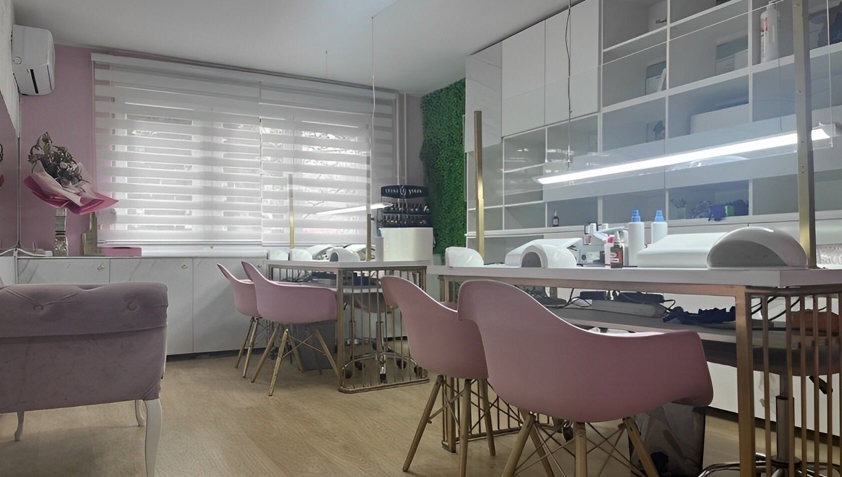 Chic salon interior at Lovely Line, Sarajevo with pink chairs and modern decor.