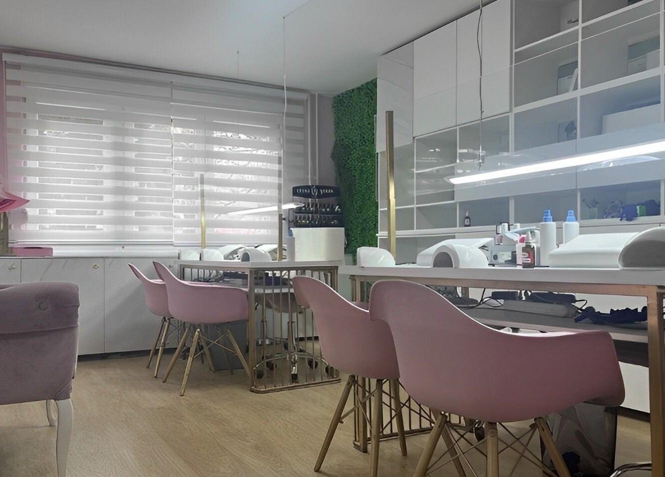 Chic salon interior at Lovely Line, Sarajevo with pink chairs and modern decor.