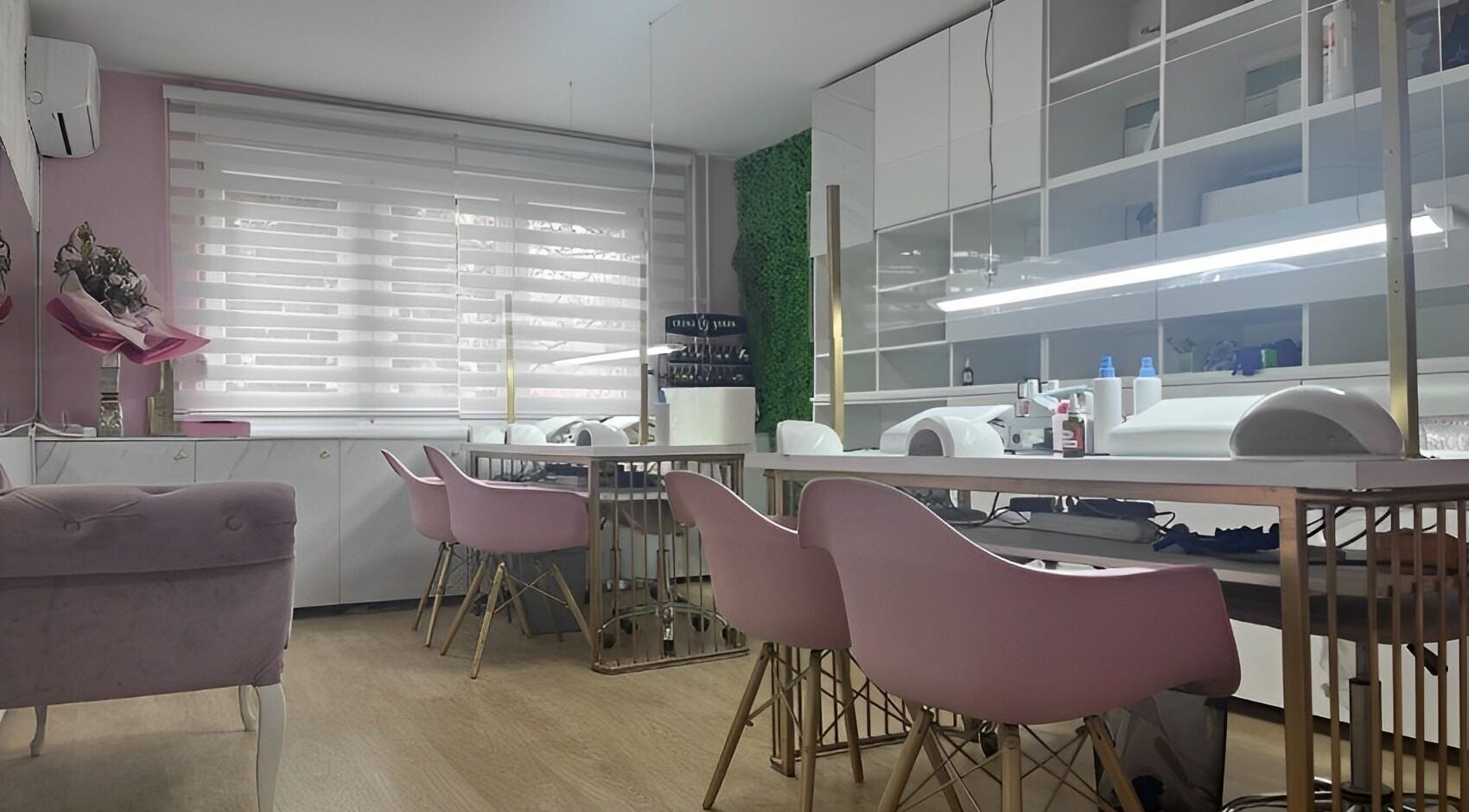 Chic salon interior at Lovely Line, Sarajevo with pink chairs and modern decor.