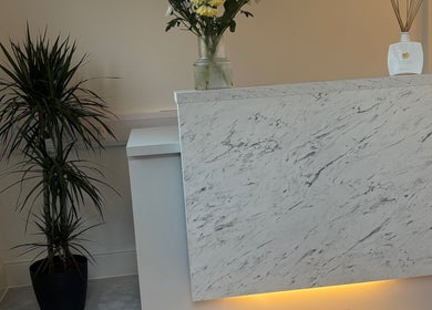 Stylish marble reception desk at Holly Jayne Hair in Derby, England, GB with modern decor accents.